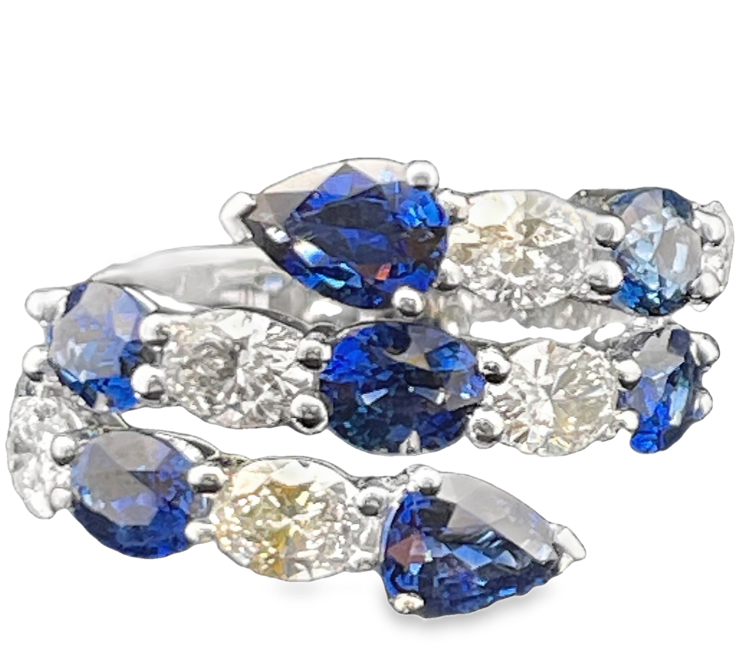 4.97TGW SAPPHIRE AND DIAMOND "COIL" RING CONTAINING: 5 OVAL + 2 PEAR SHAPE BLUE SAPPHIRES 3.51CTW + 6 OVAL DIAMONDS 1.46TDW G-H VS2-SI1 18KW
