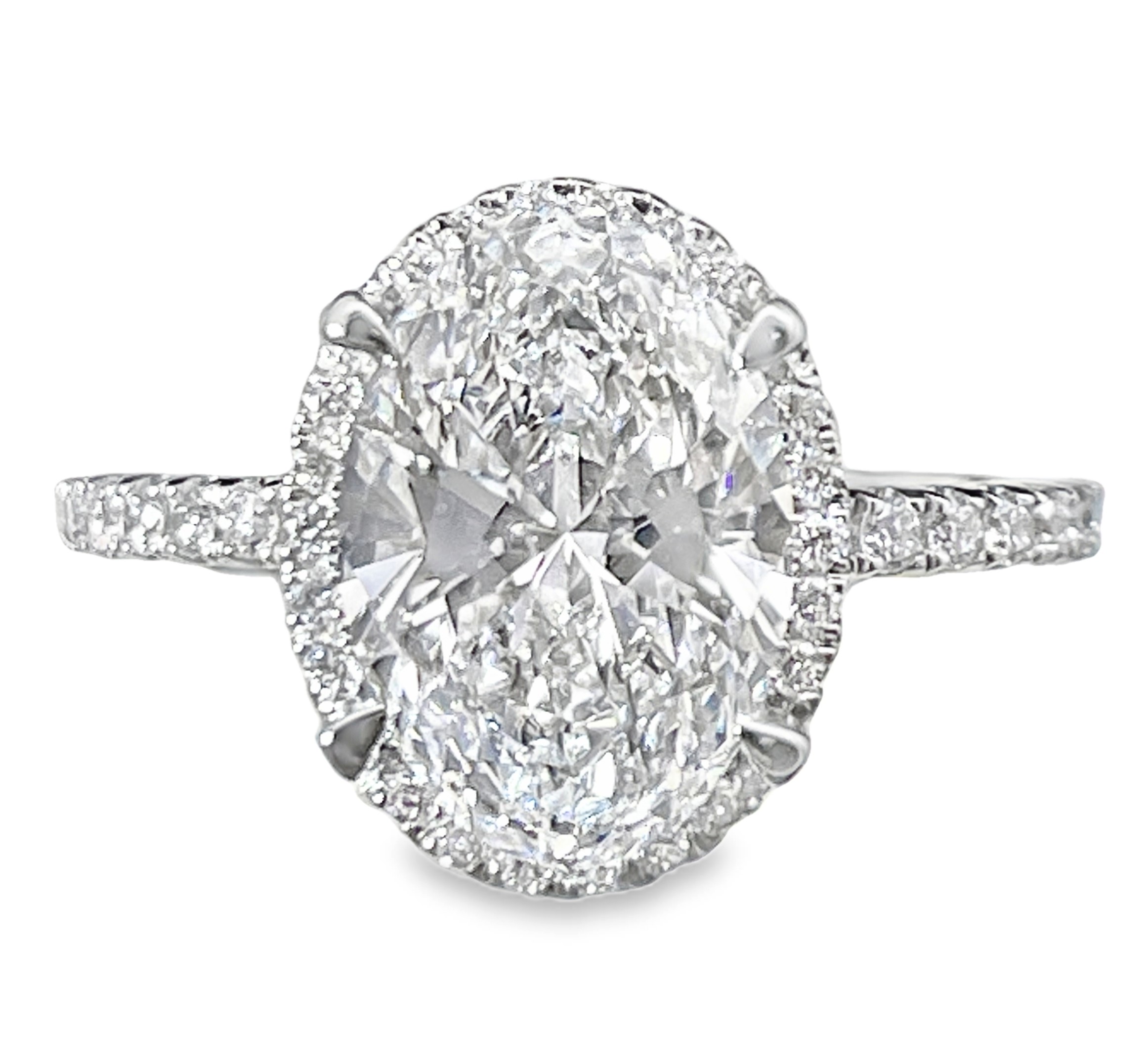 SUPER MAN MADE CREATED 3.55CTW DIAMOND OVAL HALO ENGAGMENT RING CONTAINING: 3.04CT OVAL DIAMOND CENTER E VS1 IGI LG550235828 + 58 ROUND MELEE DIAMONDS .51CTW 18KW