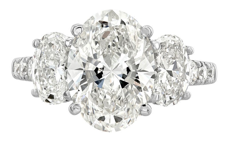 SUPER MAN MADE CREATED 5.50CTW DIAMOND 3-STONE RING CONTAINING: 3.56CT OVAL DIAMOND CENTER F VS1 IGI LG625495010 + .77CT OVAL DIAMOND E VVS2 IGI LG646456376 + .75CT OVAL DIAMOND D VVS2 IGI LG646456375 + 22 ROUND MELEE DIAMONDS .67CTW  14KW